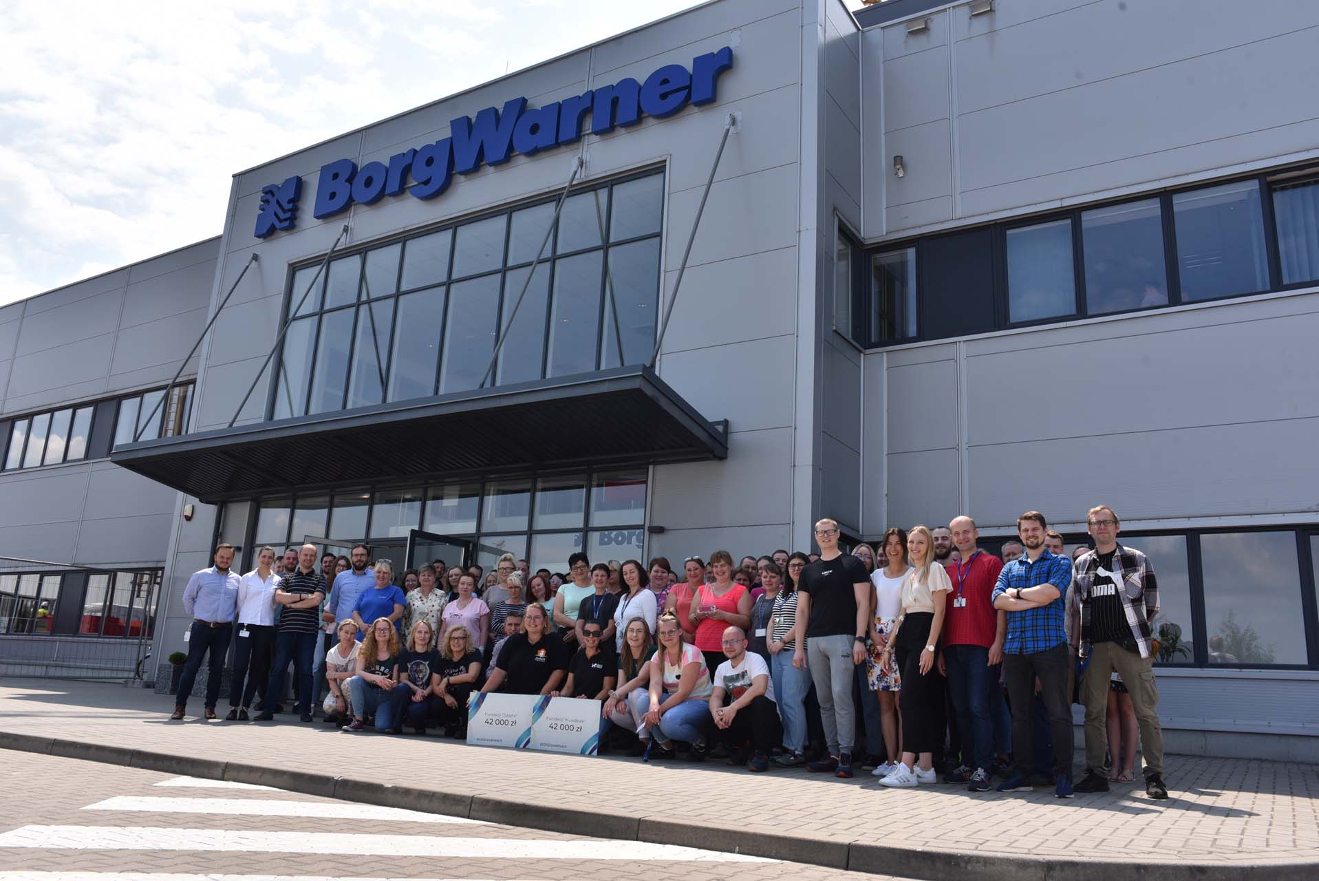 BorgWarner employees in front of building