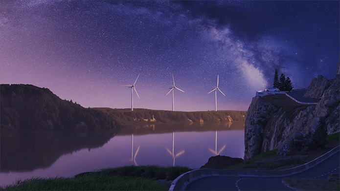 a group of windmills on a shore at night