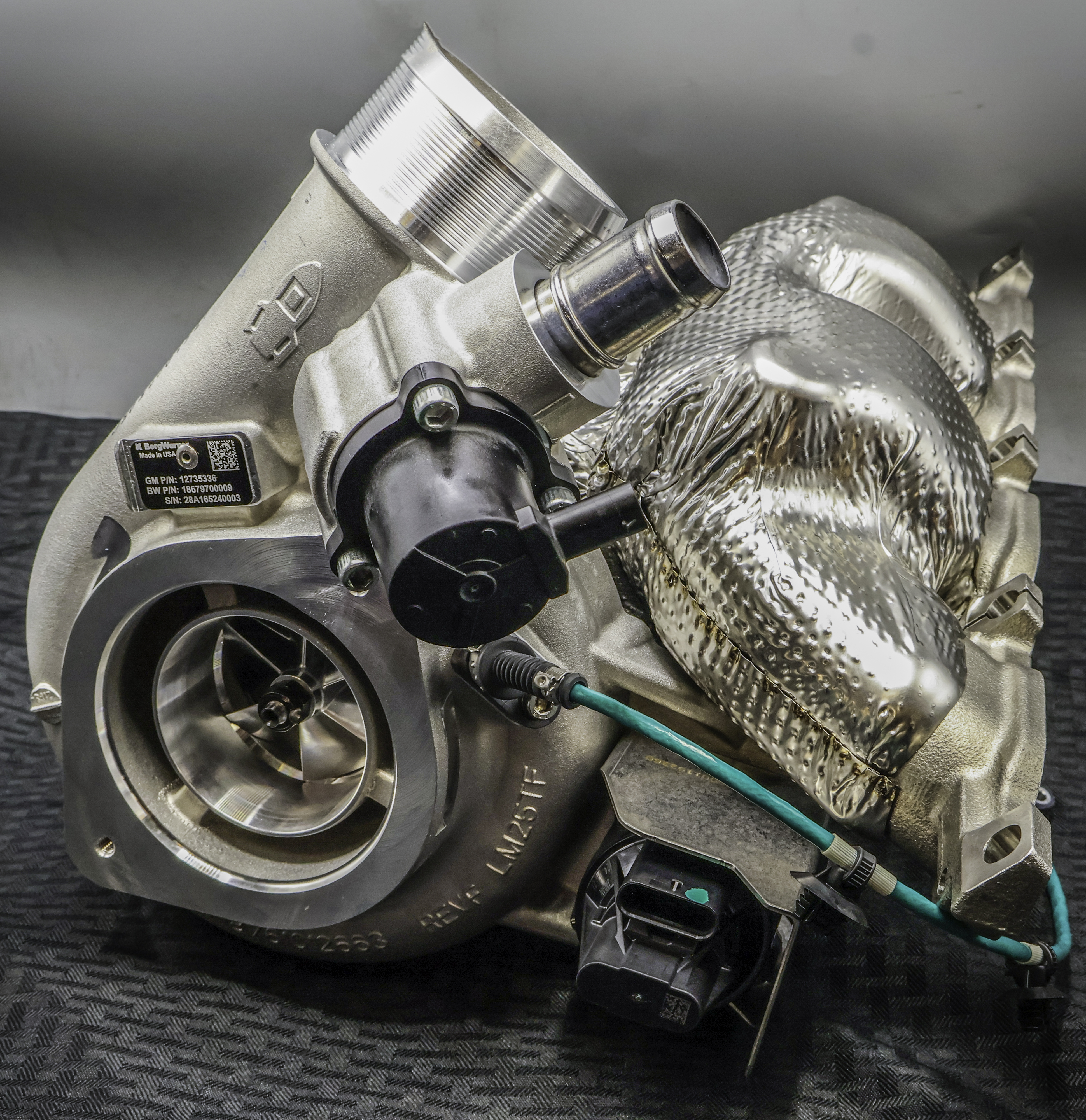 Large silver double turbocharger with grey background