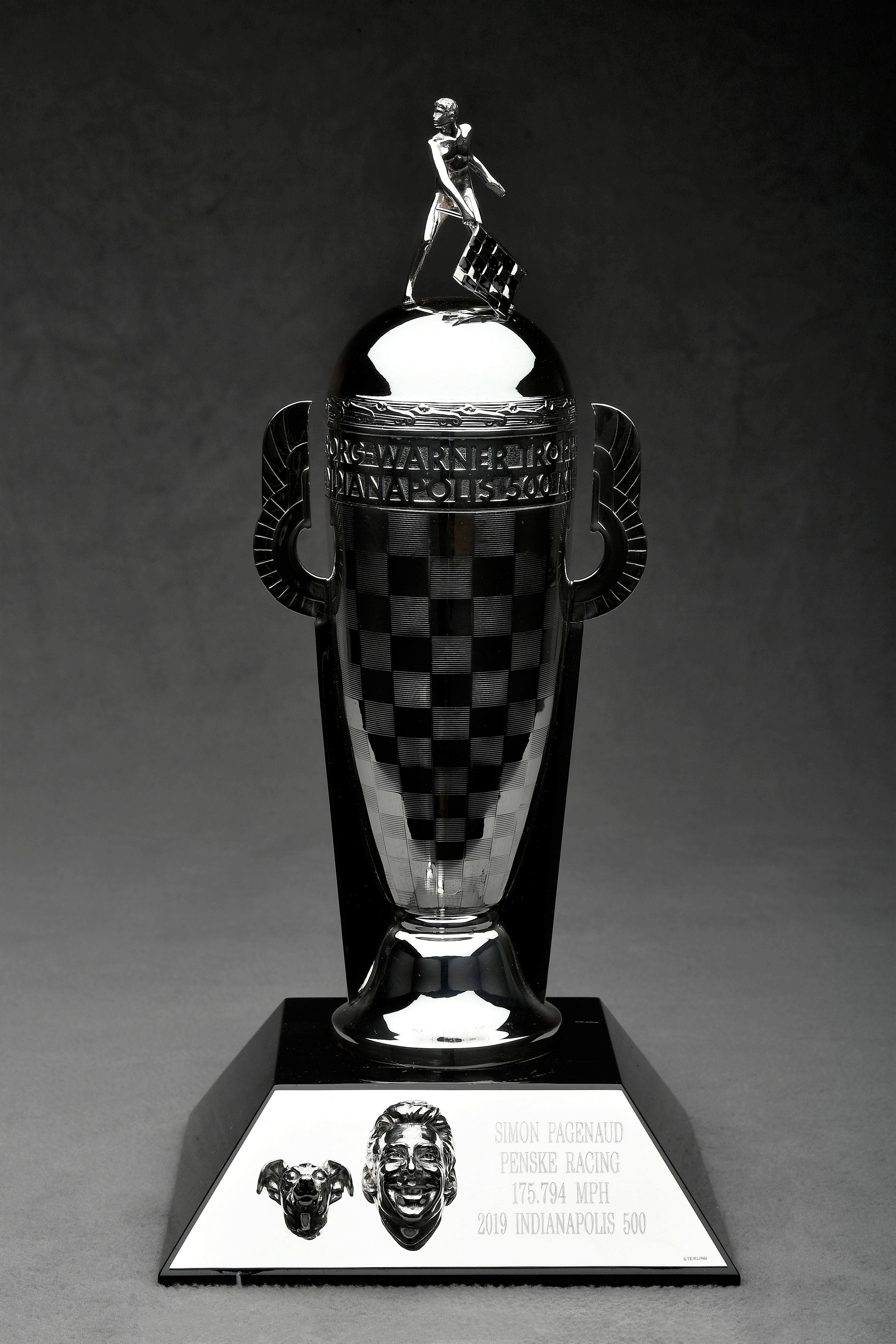a silver trophy with a checkered design