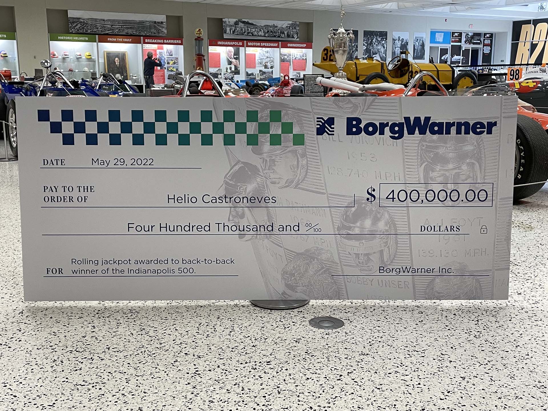 Large check worth 400,000 USD stands in racing car museum