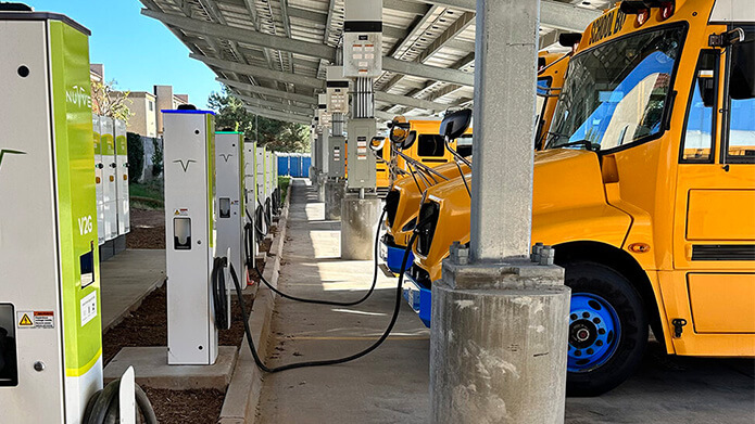 Fleet of electric American school busses charging while off duty