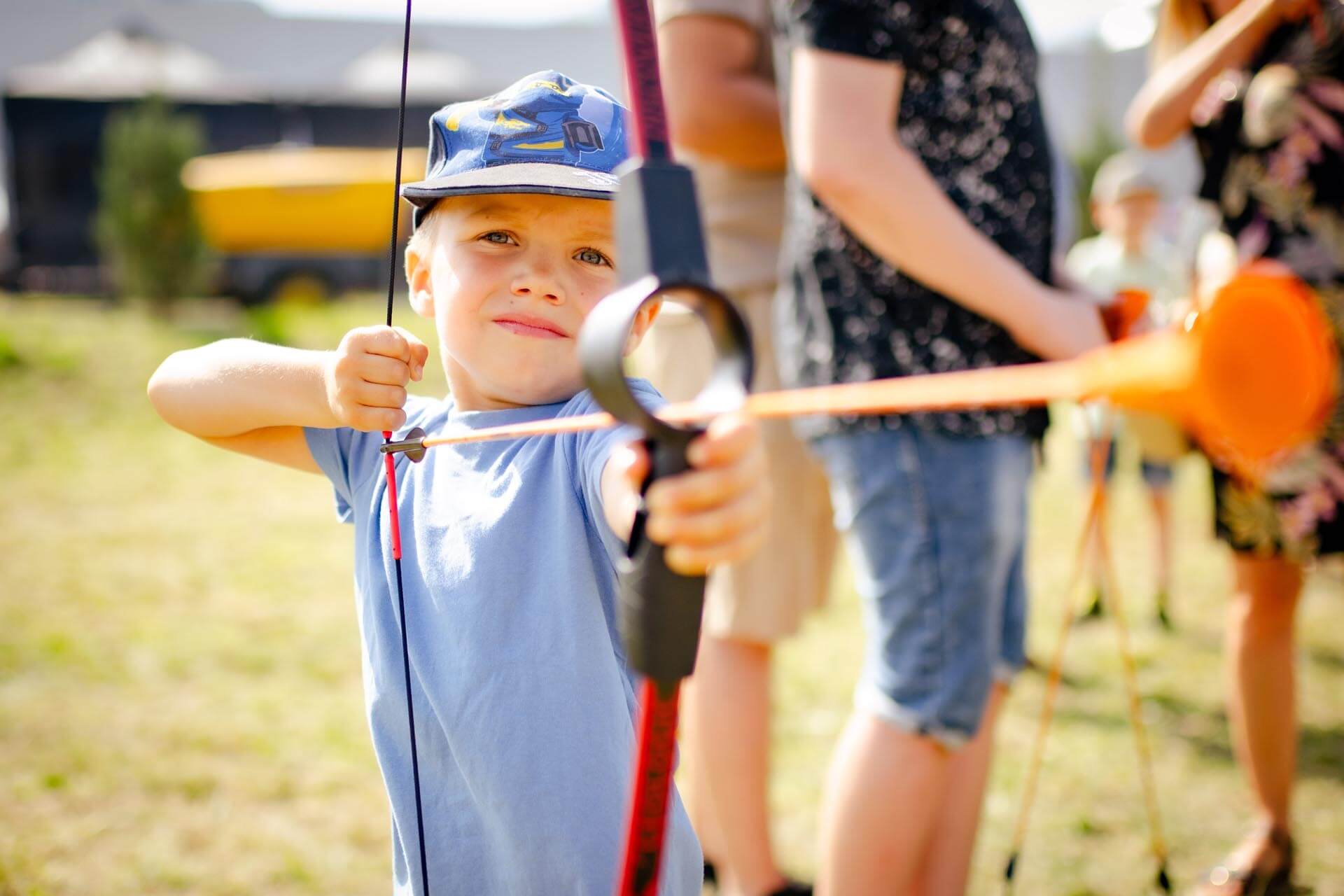 a boy holding a bow and arrow